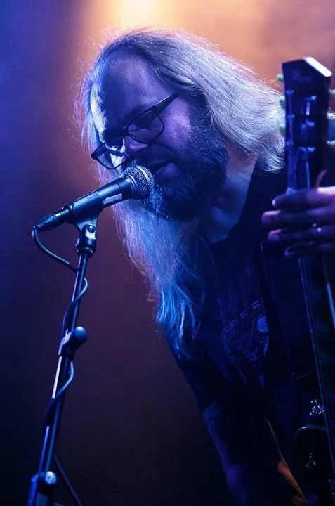 Victor Takala playing guitar at a Doomherre live show